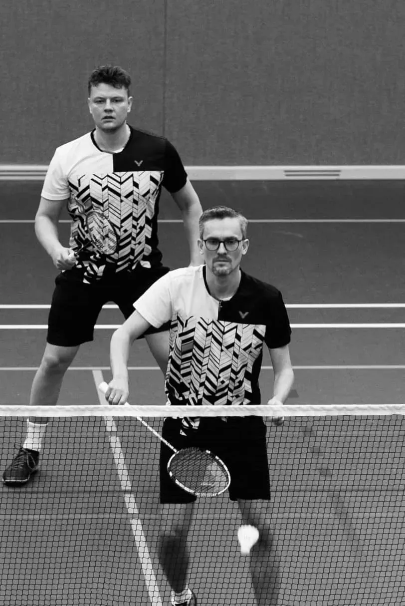 Badminton doubles match in progress